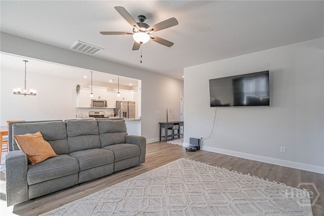 194 Gavin Way, Rincon, GA 31326 - living area featuring ceiling fan, wood finished floors, and a chandelier