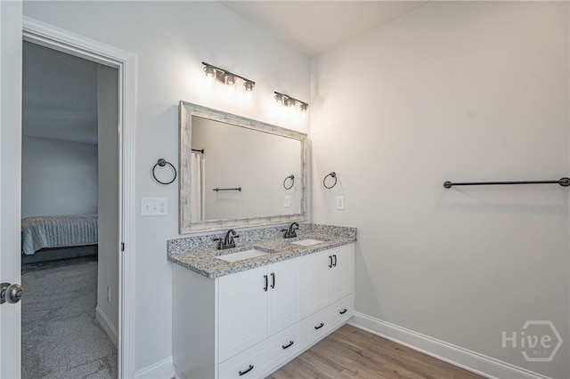 194 Gavin Way, Rincon, GA 31326 - full bathroom featuring double vanity, connected bathroom, and wood finished floors