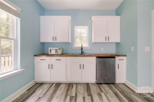118 Plantation Way, Guyton, GA 31312 - kitchen featuring dishwashing machine, light wood finished floors, white cabinetry, and wooden counters