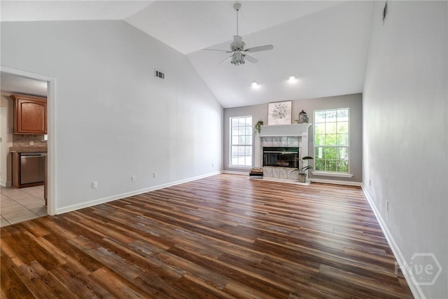 118 Plantation Way, Guyton, GA 31312 - unfurnished living room with wood finished floors, a ceiling fan, high vaulted ceiling, and a tile fireplace