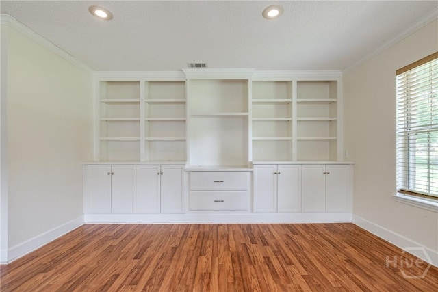 118 Plantation Way, Guyton, GA 31312 - empty room with crown molding, wood finished floors, built in shelves, a textured ceiling, and recessed lighting
