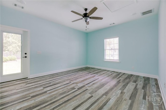 118 Plantation Way, Guyton, GA 31312 - spare room featuring wood finished floors, a ceiling fan, and attic access