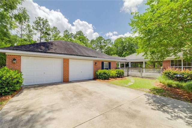 118 Plantation Way, Guyton, GA 31312 - ranch-style house featuring brick siding, concrete driveway, and a garage