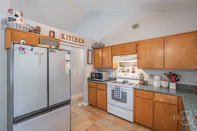 203 Deer Rd, Springfield, GA 31329 - kitchen featuring white electric range, stainless steel microwave, under cabinet range hood, freestanding refrigerator, and dark countertops