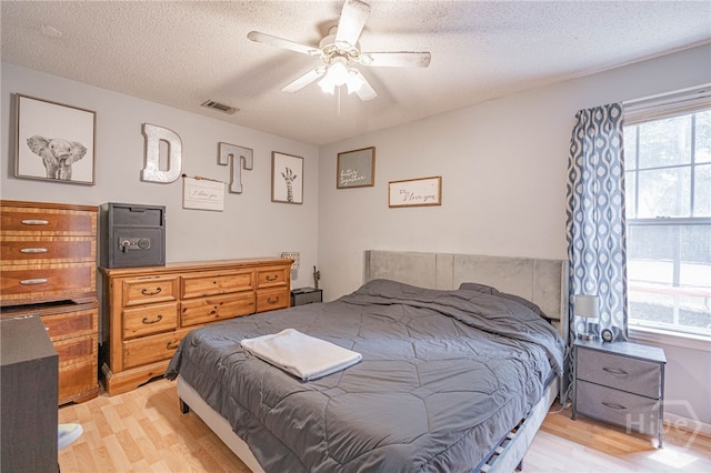 203 Deer Rd, Springfield, GA 31329 - bedroom featuring light wood finished floors, a textured ceiling, and ceiling fan
