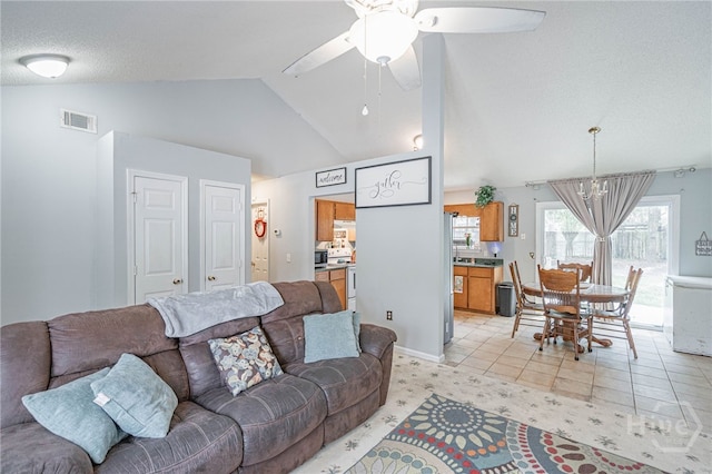 203 Deer Rd, Springfield, GA 31329 - living area featuring a chandelier, vaulted ceiling, healthy amount of natural light, a ceiling fan, and light tile patterned floors