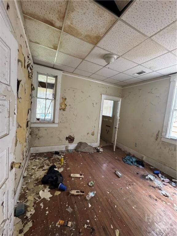601 W 45th St, Savannah, GA 31405 - empty room featuring hardwood / wood-style flooring, healthy amount of natural light, and a drop ceiling