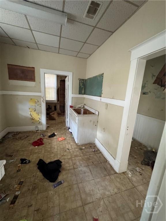 601 W 45th St, Savannah, GA 31405 - bathroom with a drop ceiling and a wainscoted wall