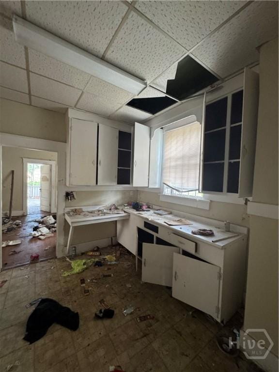 601 W 45th St, Savannah, GA 31405 - kitchen with white cabinetry, a paneled ceiling, plenty of natural light, and light countertops