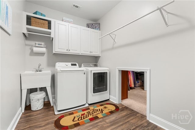 2016 Pippin Pl, Statesboro, GA 30461 - washroom with washing machine and dryer, dark wood-type flooring, and cabinet space