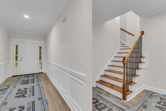 163 Sea Island Rd, Midway, GA 31320 - entrance foyer with ornamental molding, wood finished floors, stairway, wainscoting, and a decorative wall