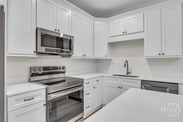 135 Houston St, Pooler, GA 31322 - kitchen featuring stainless steel appliances, light countertops, and white cabinetry