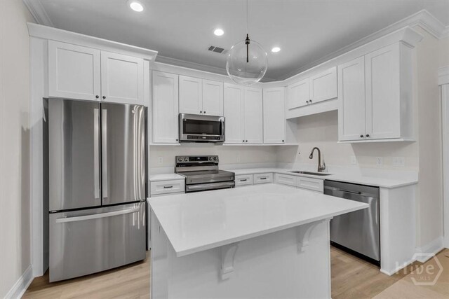 135 Houston St, Pooler, GA 31322 - kitchen featuring appliances with stainless steel finishes, light countertops, white cabinets, recessed lighting, and ornamental molding