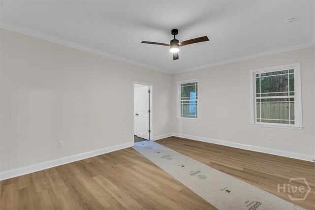135 Houston St, Pooler, GA 31322 - spare room featuring wood finished floors, a ceiling fan, ornamental molding, and healthy amount of natural light