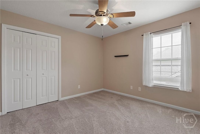 98 Peregrine Cir, Richmond Hill, GA 31324 - unfurnished bedroom with carpet flooring, a closet, and a ceiling fan