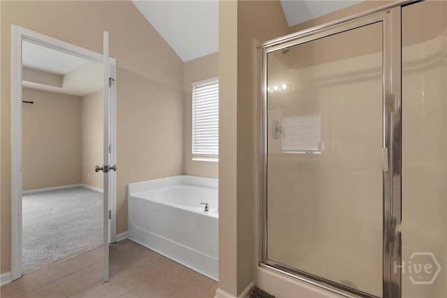 98 Peregrine Cir, Richmond Hill, GA 31324 - full bathroom featuring a bath, a shower stall, vaulted ceiling, and tile patterned floors