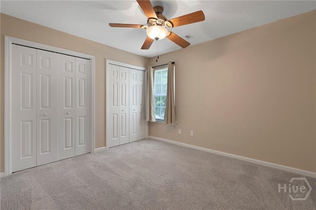 98 Peregrine Cir, Richmond Hill, GA 31324 - unfurnished bedroom with two closets, carpet, and ceiling fan
