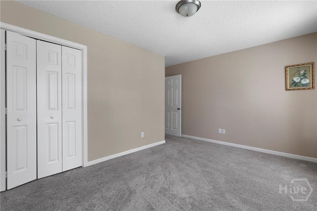 98 Peregrine Cir, Richmond Hill, GA 31324 - unfurnished bedroom featuring carpet flooring, a closet, and a textured ceiling