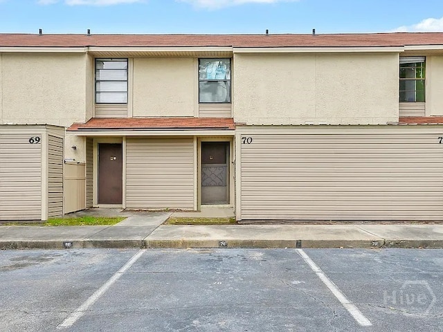 901 Olmstead Dr Unit 70, Hinesville, GA 31313 - view of front of home featuring uncovered parking and stucco siding