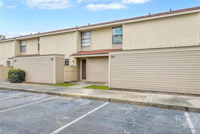 901 Olmstead Dr Unit 70, Hinesville, GA 31313 - view of front of house with uncovered parking and stucco siding