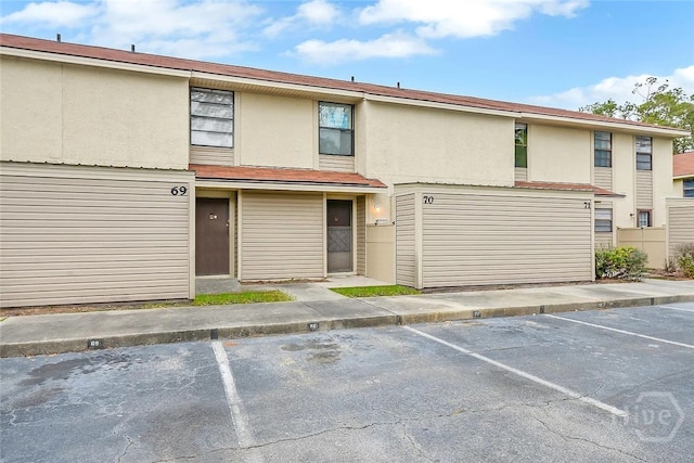 901 Olmstead Dr Unit 70, Hinesville, GA 31313 - view of front of home with uncovered parking and stucco siding