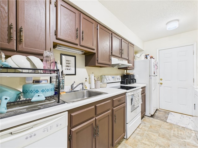 901 Olmstead Dr Unit 70, Hinesville, GA 31313 - kitchen with white appliances, under cabinet range hood, light countertops, and a textured ceiling