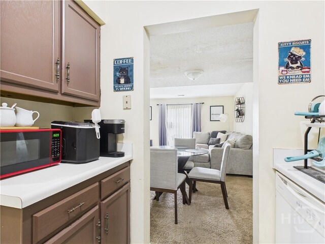 901 Olmstead Dr Unit 70, Hinesville, GA 31313 - kitchen with black microwave, light colored carpet, light countertops, and a textured ceiling