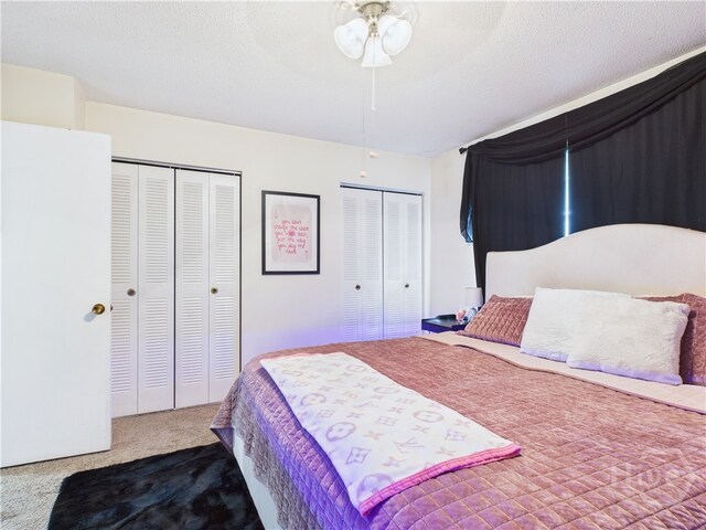 901 Olmstead Dr Unit 70, Hinesville, GA 31313 - bedroom featuring two closets, carpet floors, and a ceiling fan