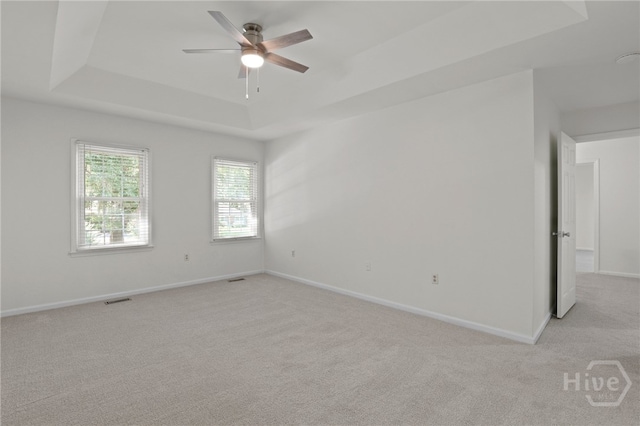 103 Olde Towne Rd, Savannah, GA 31410 - empty room with a tray ceiling, light carpet, and a ceiling fan