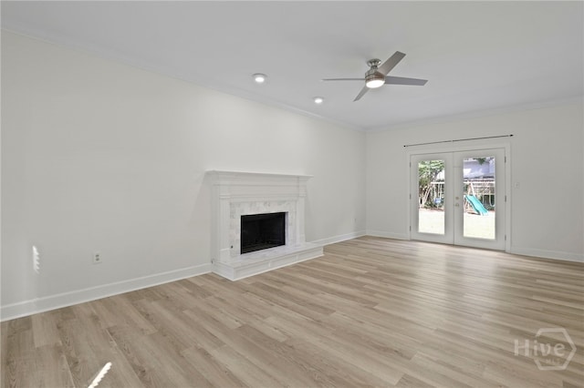 103 Olde Towne Rd, Savannah, GA 31410 - unfurnished living room featuring french doors, ceiling fan, light wood-style floors, ornamental molding, and a fireplace