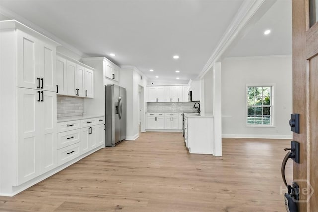 4630 Herty Dr, Savannah, GA 31405 - kitchen with stainless steel fridge, crown molding, backsplash, recessed lighting, and light countertops