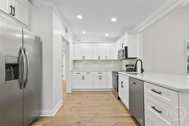 4630 Herty Dr, Savannah, GA 31405 - kitchen with appliances with stainless steel finishes, ornamental molding, a peninsula, backsplash, and recessed lighting