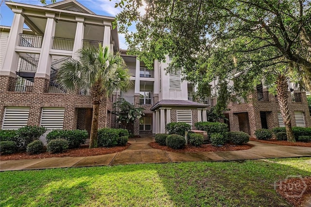 2805 River Oaks Dr Unit 2805, Richmond Hill, GA 31324 - view of front of home with brick siding, stucco siding, and a front lawn