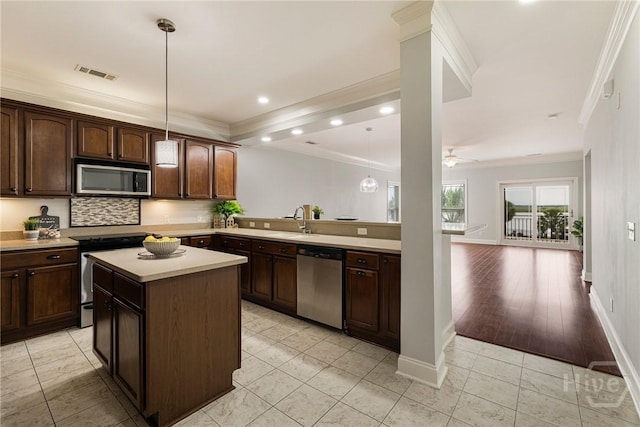 2805 River Oaks Dr Unit 2805, Richmond Hill, GA 31324 - kitchen with stainless steel appliances, crown molding, light countertops, backsplash, and dark brown cabinetry