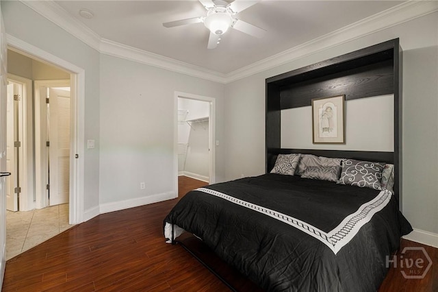 2805 River Oaks Dr Unit 2805, Richmond Hill, GA 31324 - bedroom featuring wood finished floors, ornamental molding, a ceiling fan, a spacious closet, and a closet
