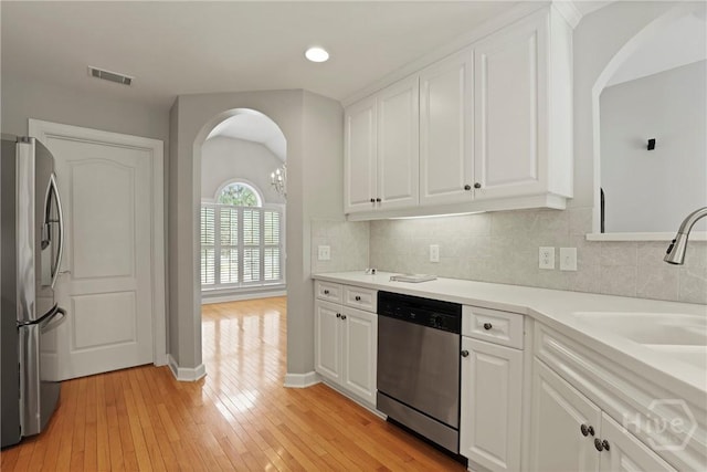 706 Southbridge Blvd, Savannah, GA 31405 - kitchen with stainless steel appliances, arched walkways, white cabinets, and recessed lighting