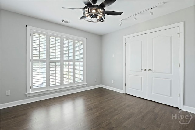 706 Southbridge Blvd, Savannah, GA 31405 - unfurnished bedroom with track lighting, dark wood-style flooring, a closet, and a ceiling fan