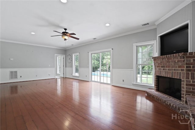 706 Southbridge Blvd, Savannah, GA 31405 - unfurnished living room with ceiling fan, wainscoting, hardwood / wood-style floors, a brick fireplace, and ornamental molding