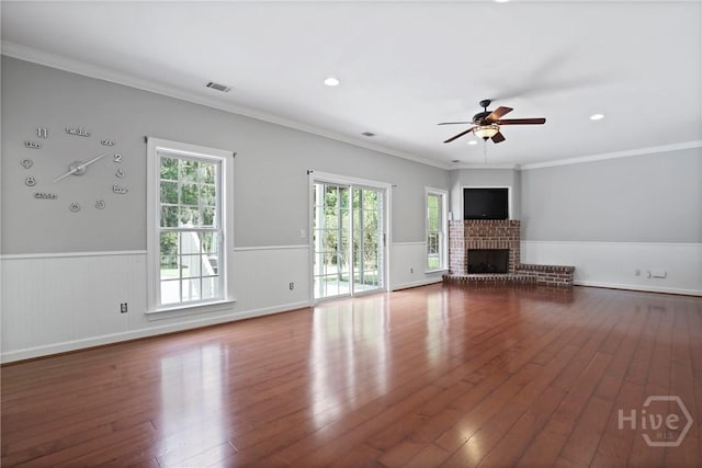 706 Southbridge Blvd, Savannah, GA 31405 - unfurnished living room featuring ceiling fan, wainscoting, hardwood / wood-style floors, a fireplace, and ornamental molding