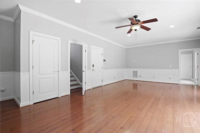 706 Southbridge Blvd, Savannah, GA 31405 - unfurnished living room with a ceiling fan, wainscoting, hardwood / wood-style floors, ornamental molding, and recessed lighting