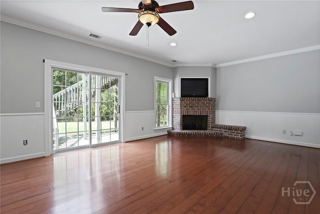 706 Southbridge Blvd, Savannah, GA 31405 - unfurnished living room featuring a wainscoted wall, hardwood / wood-style floors, ornamental molding, a fireplace, and ceiling fan