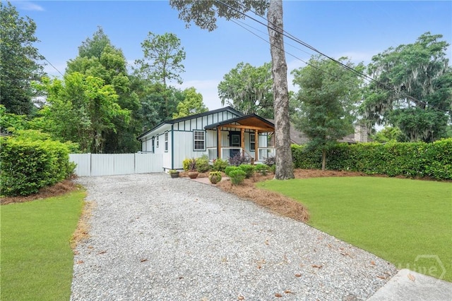 2133 Bacon Park Dr, Savannah, GA 31406 - view of front of home featuring driveway, board and batten siding, and covered porch