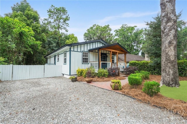 2133 Bacon Park Dr, Savannah, GA 31406 - view of front of property with board and batten siding, covered porch, and gravel driveway