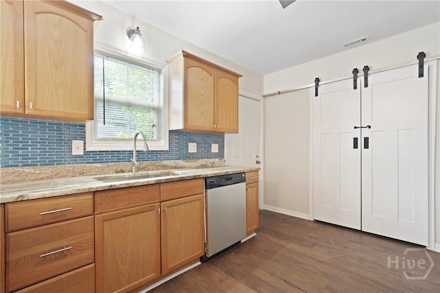 2133 Bacon Park Dr, Savannah, GA 31406 - kitchen with dishwasher, a barn door, dark wood-type flooring, and decorative backsplash