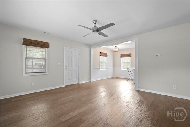 2133 Bacon Park Dr, Savannah, GA 31406 - unfurnished living room featuring ceiling fan, wood finished floors, and a chandelier