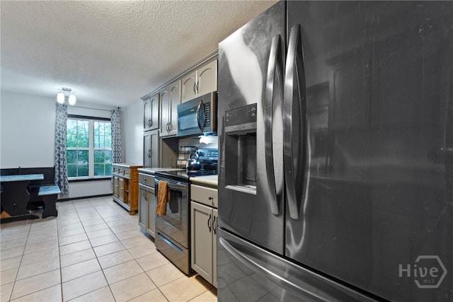 31 Pembroke Pl, Pembroke, GA 31321 - kitchen featuring stainless steel appliances, a textured ceiling, light countertops, and light tile patterned flooring