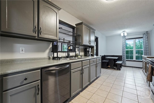 31 Pembroke Pl, Pembroke, GA 31321 - kitchen with stainless steel dishwasher, a textured ceiling, light tile patterned floors, light countertops, and gray cabinets