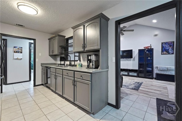 31 Pembroke Pl, Pembroke, GA 31321 - kitchen featuring a textured ceiling, light tile patterned floors, ceiling fan, light countertops, and gray cabinets