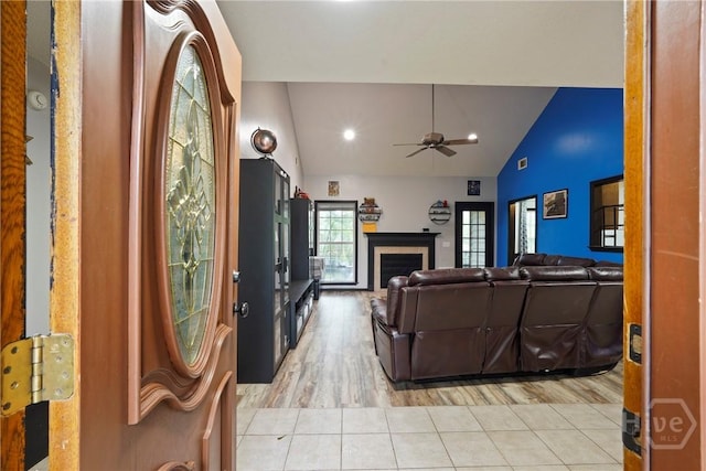 31 Pembroke Pl, Pembroke, GA 31321 - living room featuring a ceiling fan, vaulted ceiling, light tile patterned floors, and a fireplace