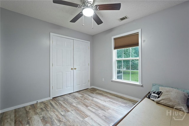 31 Pembroke Pl, Pembroke, GA 31321 - unfurnished bedroom featuring wood finished floors, a closet, a textured ceiling, and a ceiling fan